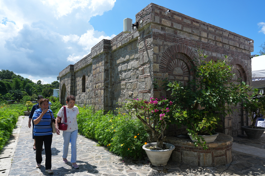 Catholic devotees walk outside the Ephesus House, a replica of the House of the Virgin Mary in Ephesus, Turkey, at Alfonso town, Cavite province, Philippines, on July 16, 2026. (AP Photo/Aaron Favila)