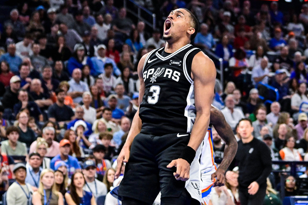 San Antonio Spurs Keldon Johnson (3) celebrates against the Oklahoma City Thunder during the first half of an NBA basketball game, Thursday, Dec. 25, 2025, in Oklahoma City. (AP Photo/Gerald Leong)