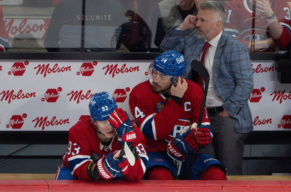 Montreal Canadiens' Ivan Demidov (93), Nick Suzuki (14) and head coach Martin St. Louis, right, watch the final minutes of play against the Buffalo Sabres in Game 6 of a second-round NHL hockey Stanley Cup playoff series in Montreal, Saturday, May 16, 2026. (Christinne Muschi/The Canadian Press via AP)