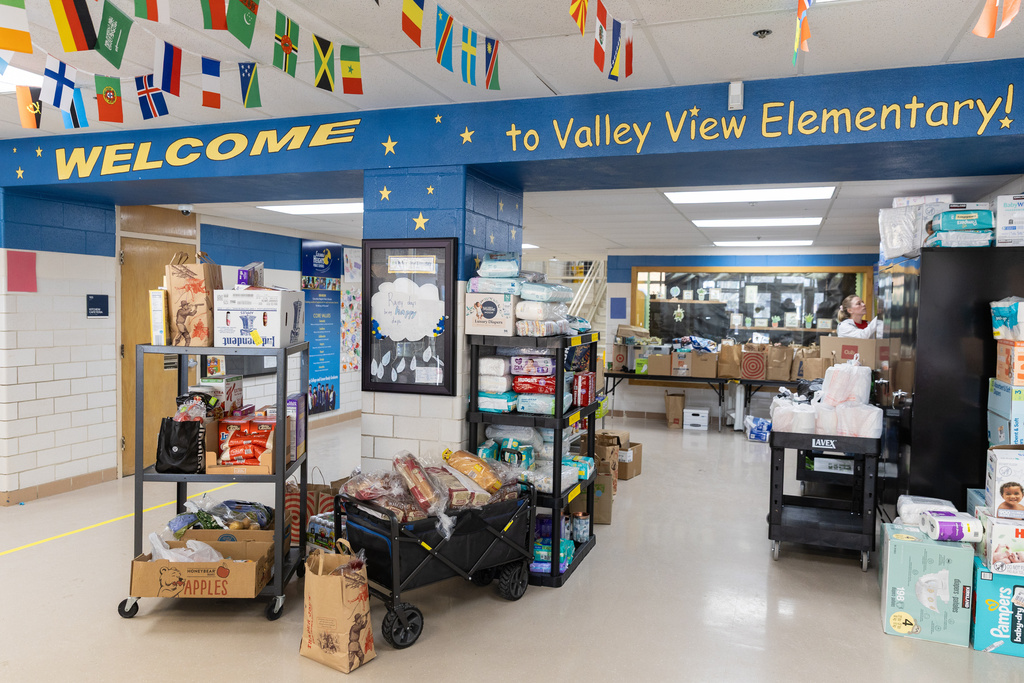 Food donations fill the inside entrance of Valley View Elementary School, Tuesday, Feb. 3, 2026, in Columbia Heights, Minn. (AP Photo/Liam James Doyle)
