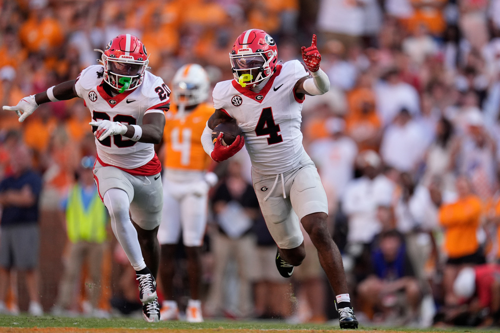 FILE - Georgia defensive back KJ Bolden (4) celebrates an interception with teammate JaCorey Thomas (20) during the second half of an NCAA college football game against Tennessee, Sept. 13, 2025, in Knoxville, Tenn. (AP Photo/George Walker IV, File)