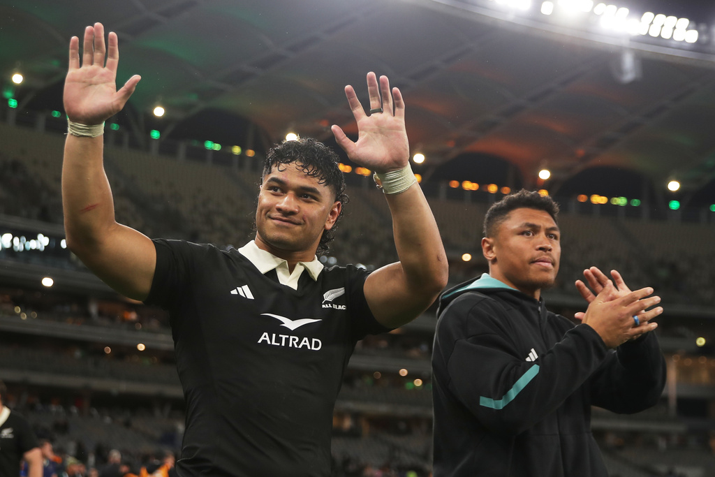 New Zealand's Wallace Sititi, left, and teammate Caleb Clarke wave to fans following the Bledisloe Cup rugby test between the All Blacks and the Wallabies in Perth, Australia, Saturday, Oct 4, 2025. (AP Photo/Gary Day)