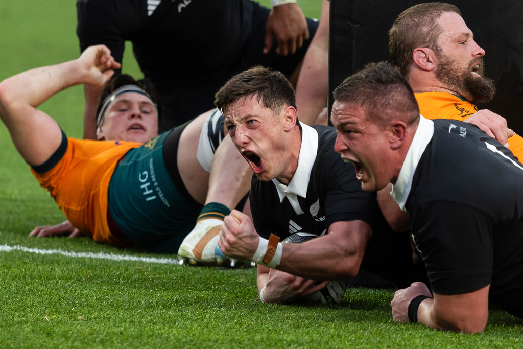 New Zealand's Cam Roigard, centre, celebrates after scoring a try during the Bledisloe Rugby test between the All Blacks and the Wallabies at Eden Park in Auckland, New Zealand, Saturday, Sept. 27, 2025. (Brett Phibbs/Photosport via AP)