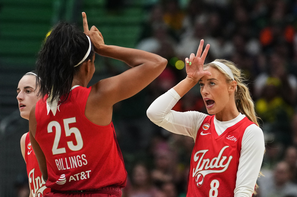 Indiana Fever guard Sophie Cunningham (8) reacts to making a basket with teammate Monique Billings (25) during the first half of a WNBA basketball game against the Seattle Storm, Tuesday, July 28, 2026, in Seattle. (AP Photo/Lindsey Wasson)