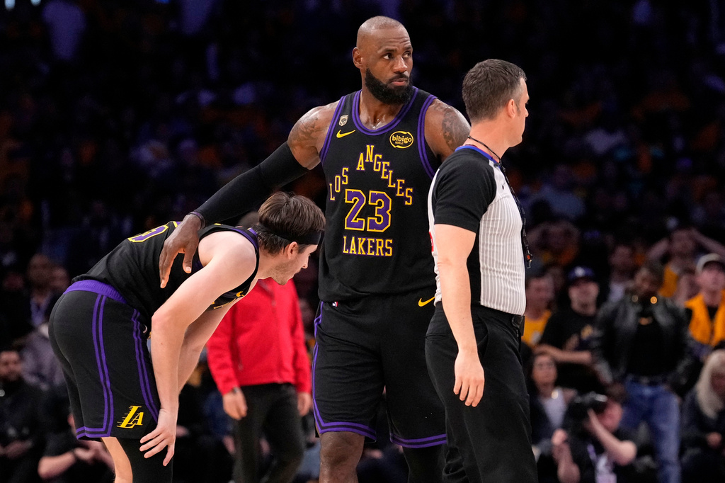 Los Angeles Lakers forward LeBron James, right, pats guard Austin Reaves after Reaves missed a three-point shot with 11 seconds left in Game 4 of a second-round NBA basketball playoffs series against the Oklahoma City Thunder, Monday, May 11, 2026, in Los Angeles. (AP Photo/Mark J. Terrill)
