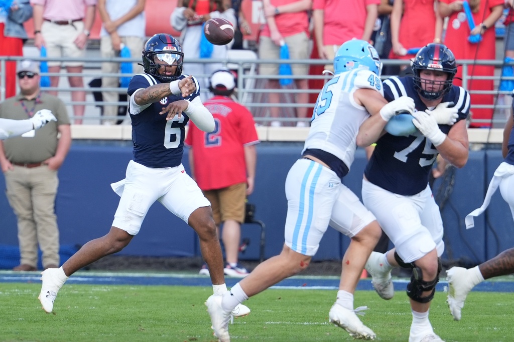 Mississippi quarterback Trinidad Chambliss (6) throws a pass behind the block of offensive lineman Patrick Kutas (75) during the first half of an NCAA college football game against The Citadel, Saturday, Nov. 8, 2025, in Oxford, Miss. (AP Photo/Rogelio V. Solis)