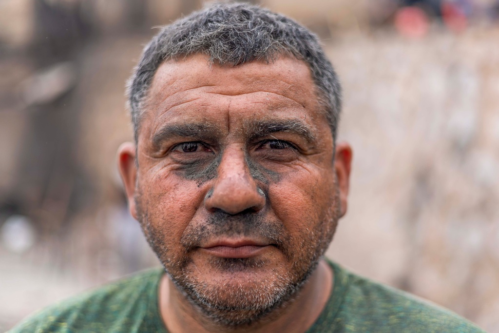 Juan Garrido poses for a portrait while cleaning up debris at his home that was destroyed by wildfires in Lirquen, Chile, Tuesday, Jan. 20, 2026. (AP Photo/Javier Torres)