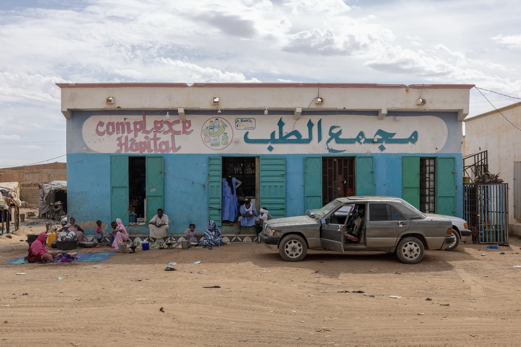 People who fled violence in Mali stand in front of the Bassikounou hospital in the Hodh El Chargui Region, where they found refuge in Mauritania, Nov. 7, 2025. (AP Photo/Caitlin Kelly)