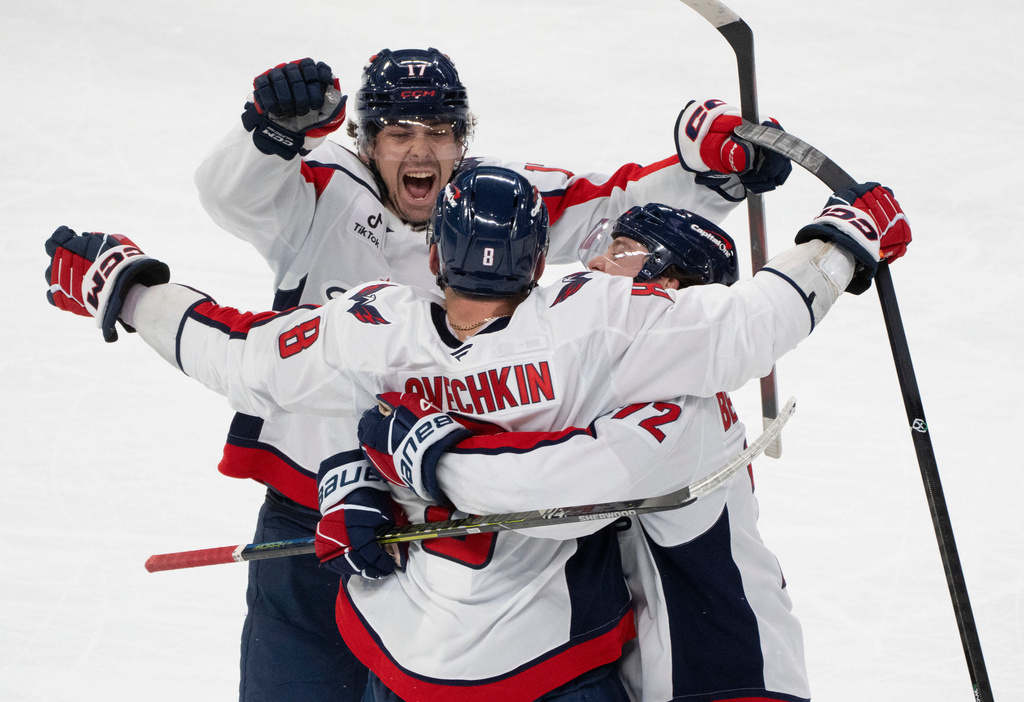 Washington Capitals' Alex Ovechkin (8) celebrates his hat trick against the Montreal Canadiens with teammates Dylan Strome (17) and Anthony Beauvillier (72) during third period NHL hockey action in Montreal on Thursday, Nov. 20, 2025. (Christinne Muschi/The Canadian Press via AP)