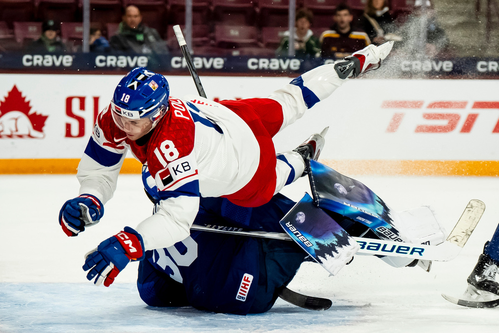 Czechia's Tomas Poletin (18) collides with Finland goaltender Petteri Rimpinen (30) during first period match at the world junior hockey championship in Minneapolis, Monday, Dec. 29, 2025. (Christopher Katsarov/The Canadian Press via AP)