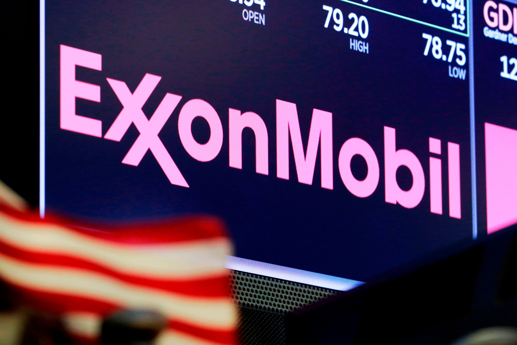 FILE - The logo for ExxonMobil appears above a trading post on the floor of the New York Stock Exchange, April 23, 2018. (AP Photo/Richard Drew, File)