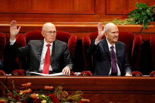 FILE - President Russell M. Nelson, right, raises his hand during a sustaining vote with his counselor, Dallin H. Oaks, left, during The Church of Jesus Christ of Latter-day Saints' twice-annual church conference Oct. 5, 2019, in Salt Lake City. (AP Photo/Rick Bowmer, File) FILE - President Russell M. Nelson, right, raises his hand during a sustaining vote with his counselor, Dallin H. Oaks, left, during The Church of Jesus Christ of Latter-day Saints' twice-annual church conference Oct. 5, 2019, in Salt Lake City. (AP Photo/Rick Bowmer, File)