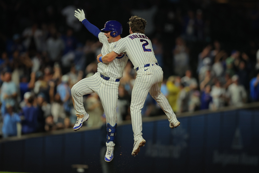 Chicago Cubs' Alex Bregman celebrates teammate Nico Hoerner after hitting the game winning hit to score Carson Kelly during the ninth inning of a baseball game against the Chicago White Sox, Tuesday, Aug. 18, 2026, in Chicago. (AP Photo/Melissa Tamez)