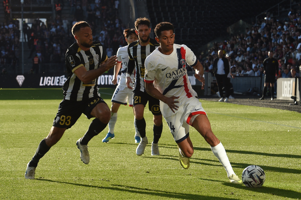 PSG's Senny Mayulu, right, challenges for the ball with Angers' Haris Belkebla, left, during the French League One soccer match between Angers and Paris Saint-Germain in Angers, western France, Saturday, April 25, 2026. (AP Photo/Mathieu Pattier)