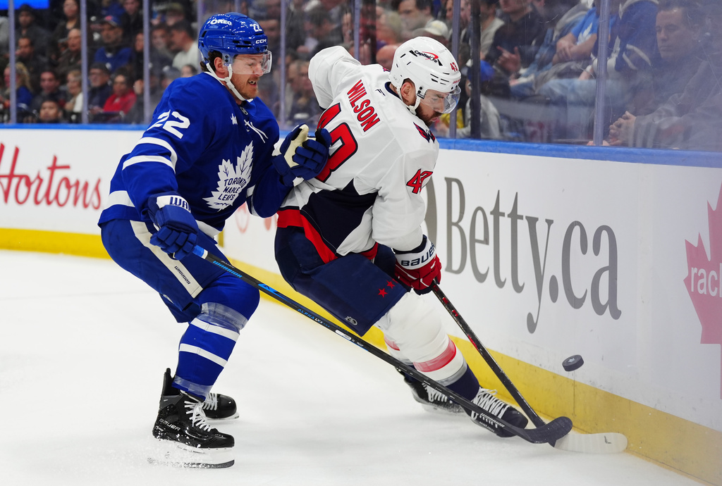 Toronto Maple Leafs' Jake McCabe (22) checks Washington Capitals' Tom Wilson (43) during first period NHL hockey action in Toronto on Wednesday, April 8, 2026. (Frank Gunn/The Canadian Press via AP)