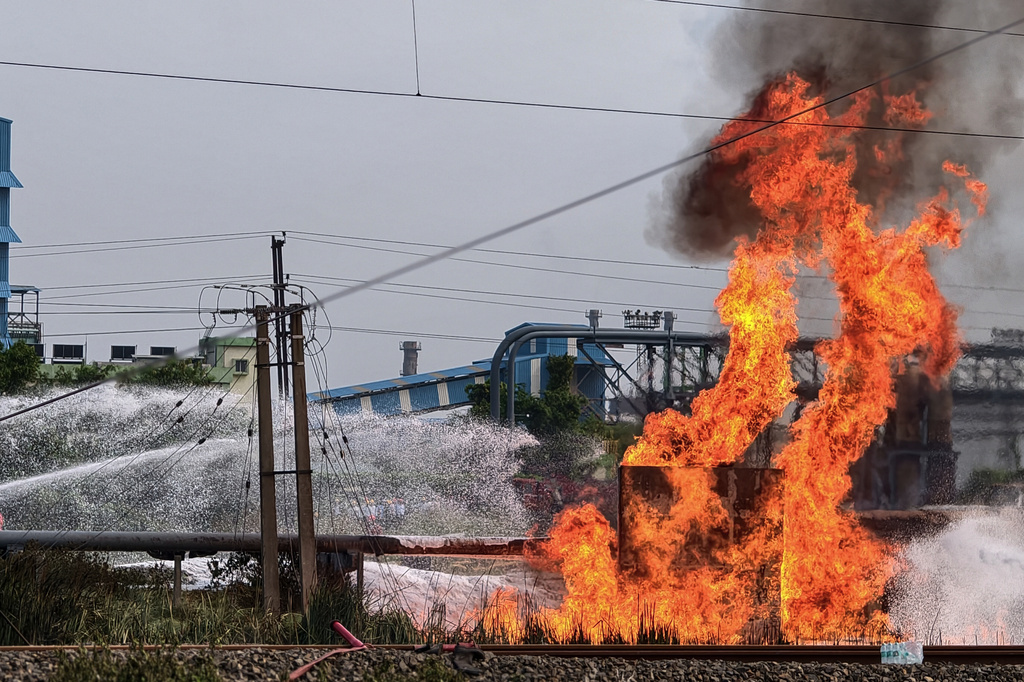 Firefighters spray water to extinguish a fire at a petrochemical plant in Purba Medinipur district, about 130 kilometers (80 miles) southwest of Kolkata, the capital of India's West Bengal state, Tuesday, June 30, 2026. (AP Photo)