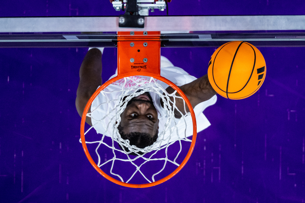 Washington Huskies center Franck Kepnang dunks during warmups before an NCAA college basketball game against the Iowa Hawkeyes, Wednesday, Feb. 4, 2026, in Seattle. (AP Photo/Maddy Grassy)