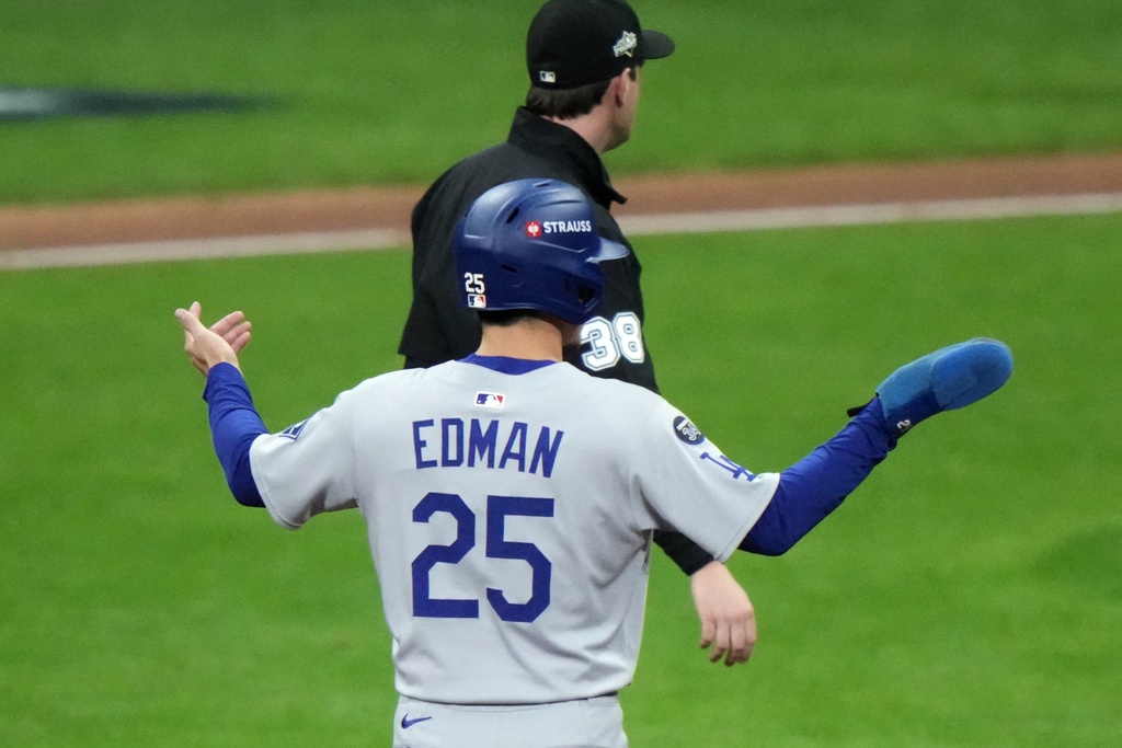 Los Angeles Dodgers' Tommy Edman reacts after a triple play during the fourth inning of Game 1 of baseball's National League Championship Series against the Milwaukee Brewers Monday, Oct. 13, 2025, in Milwaukee. (AP Photo/Morry Gash)
