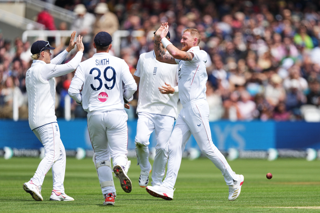 England's captain Ben Stokes, right, celebrates with teammates after the dismissal of New Zealand's Devon Conway during the fourth day of the Test match between England and New Zealand at Lord's cricket ground in London, Sunday, June 7, 2026. (AP Photo/Kirsty Wigglesworth)
