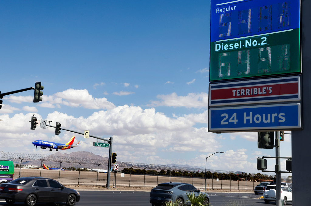 A Terrible's gas station on Sunset Road displays its gas prices as a Southwest Airlines plane prepares to land at Harry Reid International Airport Friday, Sept. 18, 2026, in Las Vegas. (Bizuayehu Tesfaye/Las Vegas Review-Journal via AP)