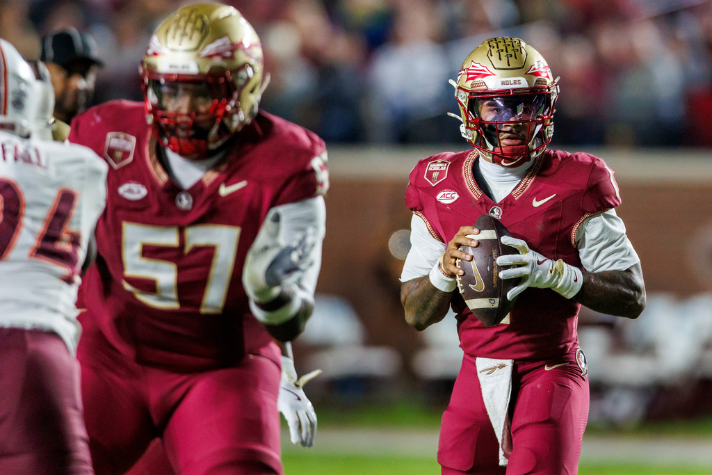 Florida State quarterback Tommy Castellanos,right, looks for a receiver during the first half of an NCAA college football game against Virginia Tech, Saturday, Nov. 15, 2025, in Tallahassee, Fla. (AP Photo/Colin Hackley)