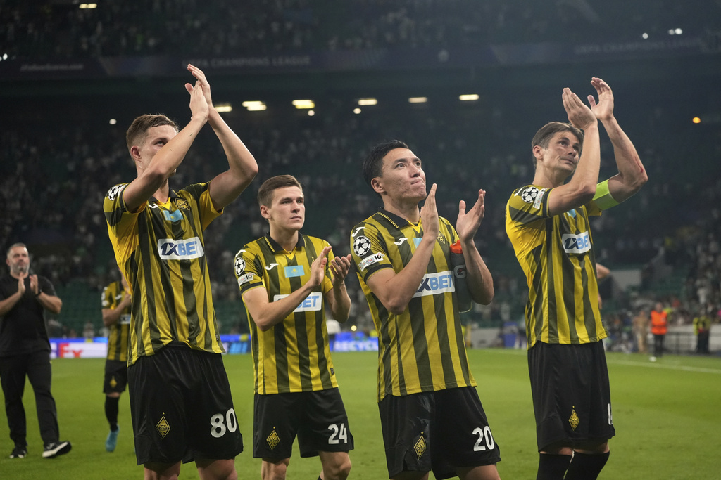 Kairat players applaud their supporters at the end of the Champions League opening phase soccer match between Sporting CP and Kairat Almaty at the Alvalade stadium in Lisbon, Thursday, Sept. 18, 2025. (AP Photo/Ana Brigida)
