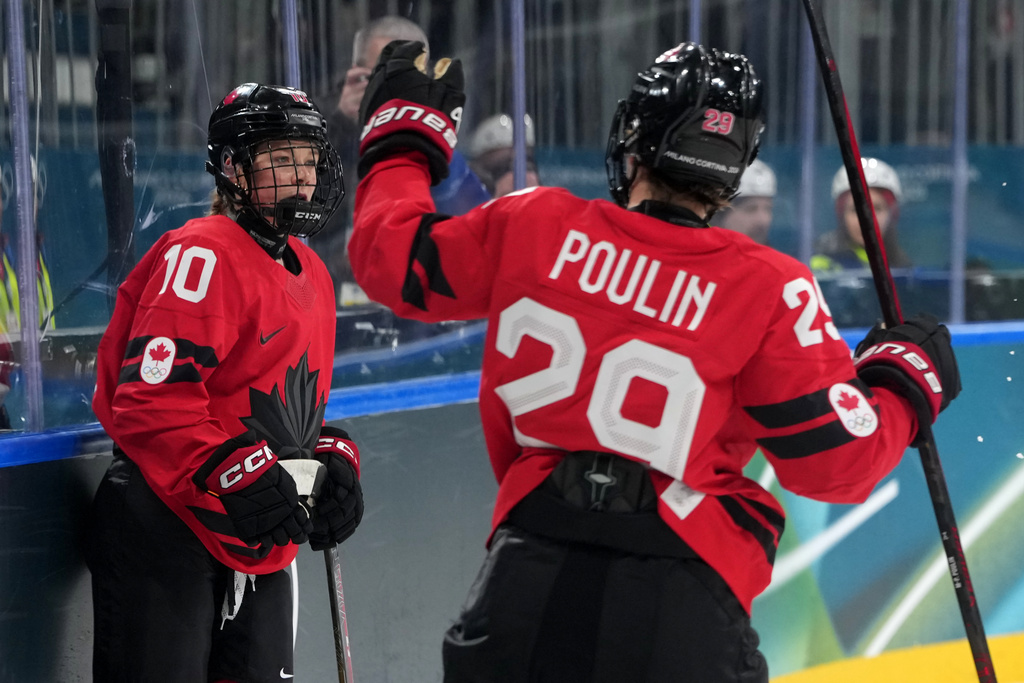 Canada's Sarah Fillier (10) is congratulated by Marie-Philip Poulin (29) after Fuller scored a goal against Germany during the second period of a women's ice hockey quarterfinal match at the 2026 Winter Olympics, in Milan, Italy, Saturday, Feb. 14, 2026. (AP Photo/Carolyn Kaster)