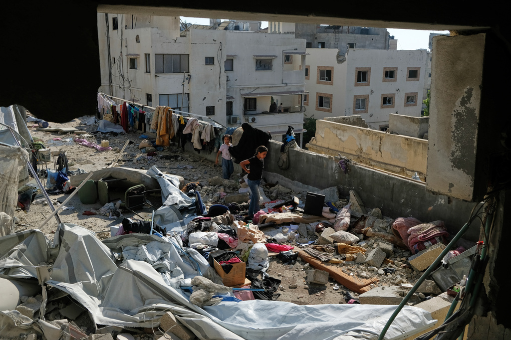 Residents inspect the site of an Israeli airstrike in Gaza city, Saturday, July 18, 2026. (AP Photo/Jehad Alshrafi)