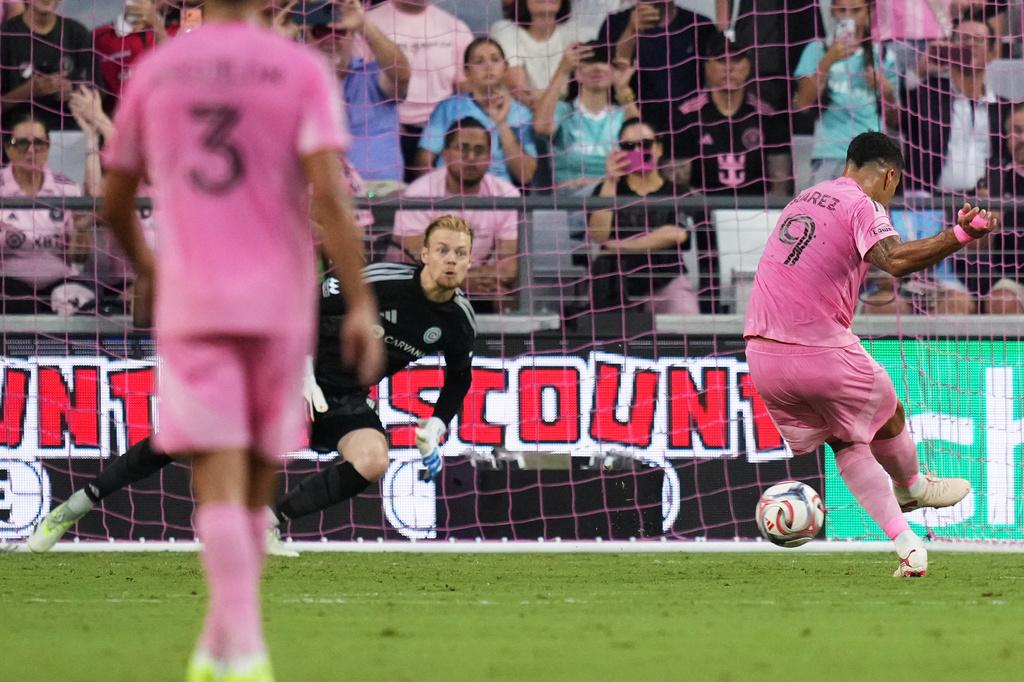 Inter Miami forward Luis Suárez (9) scores on a penalty kick past Chicago Fire goalkeeper Chris Brady during the first half of an MLS soccer match, Wednesday, July 22, 2026, in Miami. (AP Photo/Lynne Sladky)