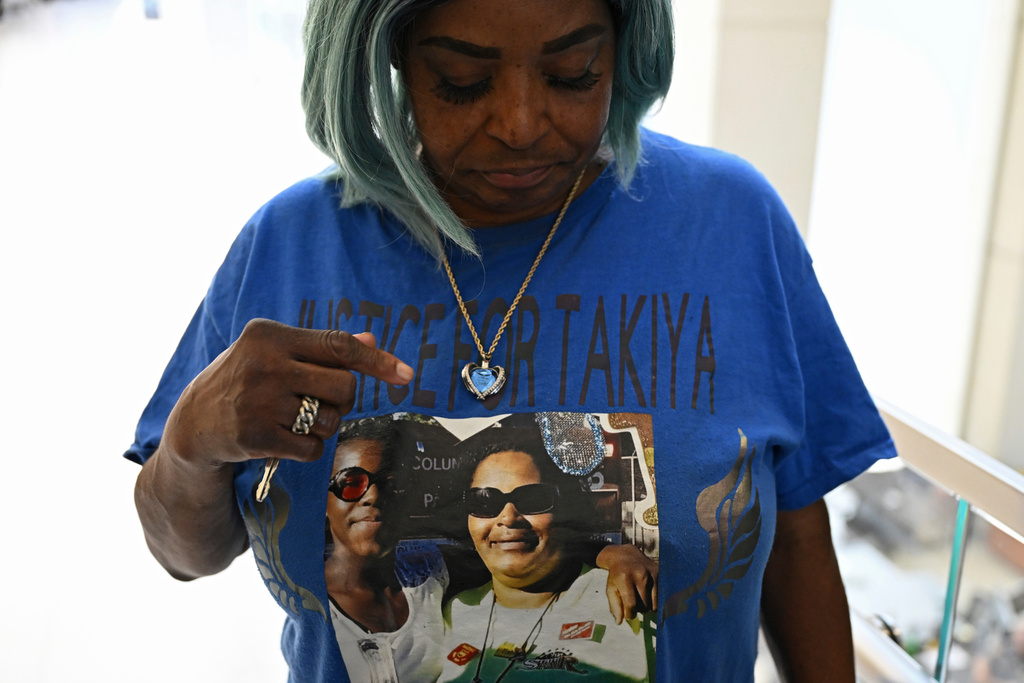 FILE - Nadine Young, grandmother of Ta'Kiya Young, shows her shirt to reporters after arraignment proceedings of Blendon Township police officer Connor Grubb, Aug. 14, 2024, at the Franklin County Court of Common Pleas in Columbus. (AP Photo/David Dermer, file)
