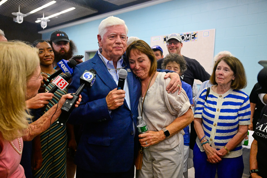 Rep. John Larson, D-Conn., speaks while hugging his wife, Leslie Larson, right, during an election night watch party Tuesday, Aug. 11, 2026, in East Hartford, Conn. (AP Photo/Jessica Hill)