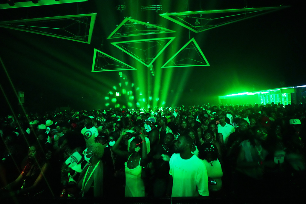 People dance in an auditorium to house music during a rave known as Group Therapy in Lekki, an upscale part of Lagos, Nigeria, Saturday, Feb. 28, 2026. (AP Photo/Sunday Alamba)