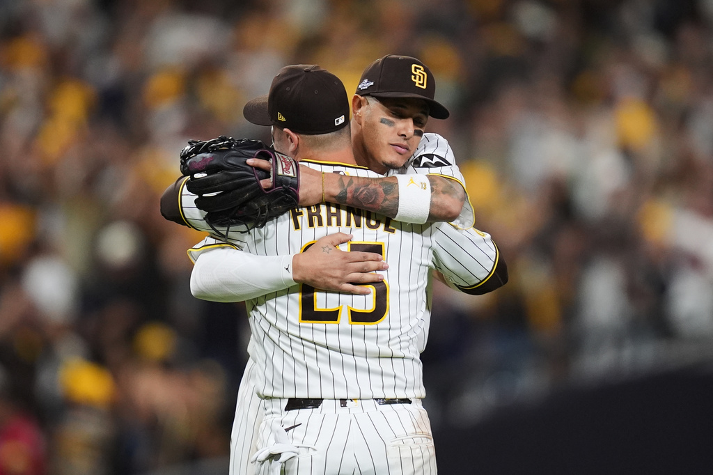 San Diego Padres third baseman Manny Machado celebrates with first baseman Ty France (25) after defeating the Chicago Cubs in Game 2 of the National League Wild Card baseball playoff series Wednesday, Sept. 30, 2026, in San Diego. (AP Photo/Gregory Bull)