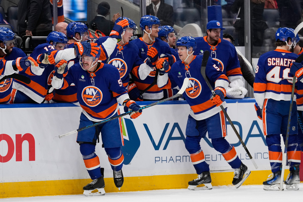 New York Islanders' Casey Cizikas (53), front left, celebrates his empty net goal with teammates during the third period of an NHL hockey game against the Colorado Avalanche, Thursday, Dec. 4, 2025, in Elmont, N.Y. (AP Photo/Seth Wenig)