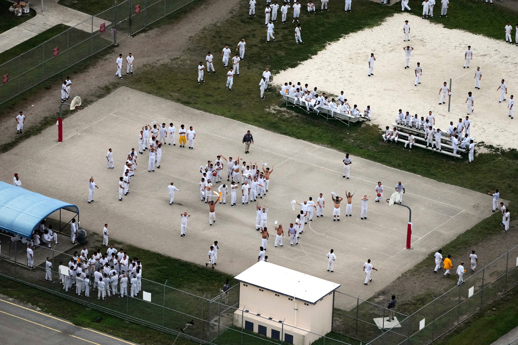 Detainees wave and spell out SOS to a helicopter flying overhead, at the U.S. Immigration and Customs Enforcement's Krome Detention Center, July 4, 2025, in Miami. (AP Photo/Rebecca Blackwell, File)