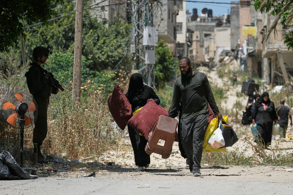 Palestinians collect their belongings from their evacuated homes after the Israeli army issued a number of short term access permits for residents of the occupied West Bank refugee camp of Tulkarem, Wednesday, June 17, 2026. (AP Photo/Majdi Mohammed)