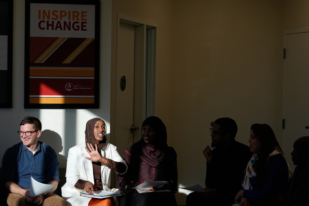 Dr. Bryan Fate, left, family nurse practitioner and CEO of Inspire Change Clinic Munira Maalimisaq, middle left, and panelist Mirad Farah, middle, lead a community discussion on vaccine education at Inspire Change Clinic, Nov. 22, 2025, in Minneapolis. (AP Photo/Abbie Parr)