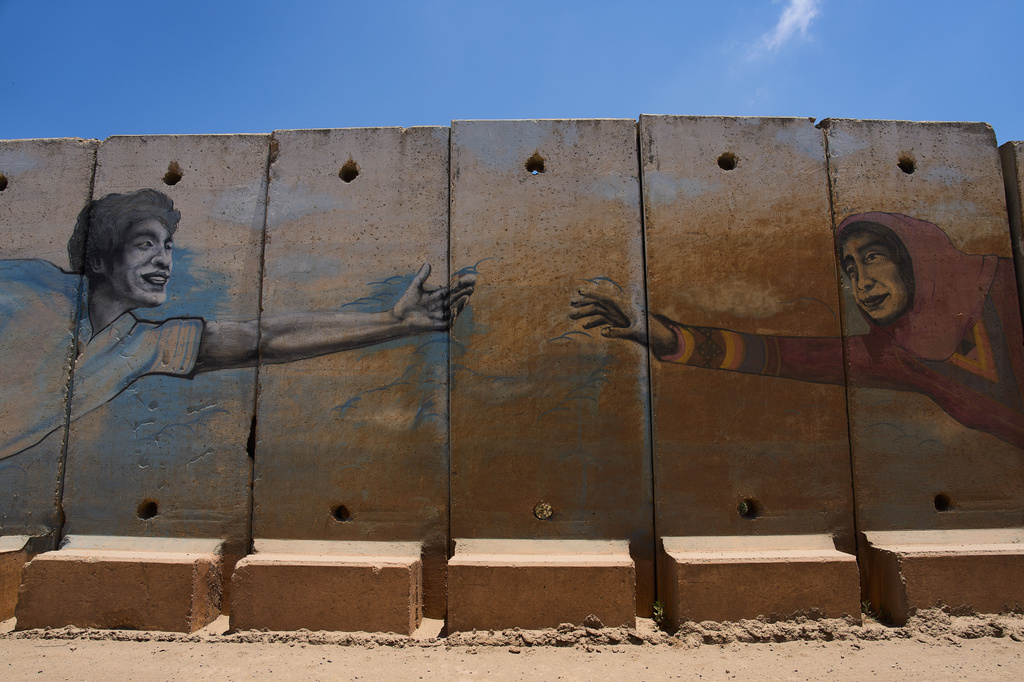 Paintings on a security wall on the border with Lebanon in northern Israel, Saturday, June 27, 2026 after Israel and Lebanon sign a framework agreement, described as a first step toward peace following months of conflict between Israel and the Lebanese militant group Hezbollah. (AP Photo/Ariel Schalit)