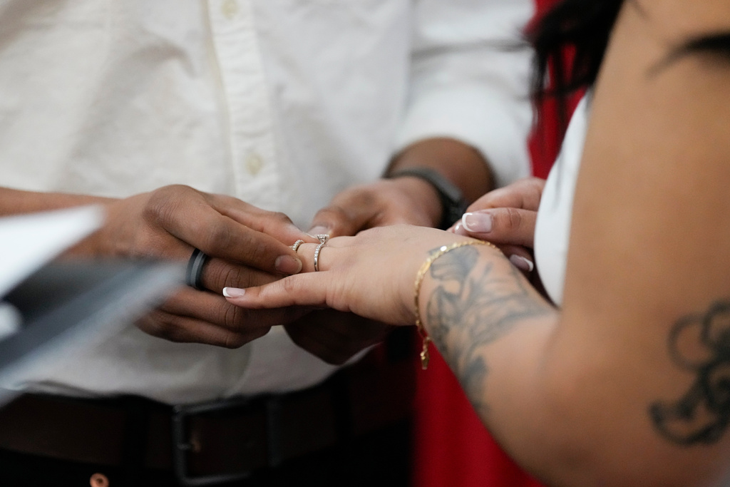 A groom, left, places a ring on the finger of the bride during their Valentines Day wedding ceremony Friday, Feb. 14, 2025, in Nashville, Tenn. (AP Photo/George Walker IV, File)