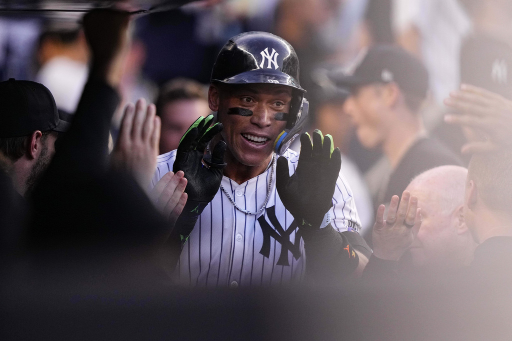 New York Yankees designated hitter Aaron Judge (99) celebrates with teammates after hitting a home run during the first inning of a baseball game against the Minnesota Twins, Tuesday, Aug. 12, 2025, in New York. (AP Photo/Yuki Iwamura)