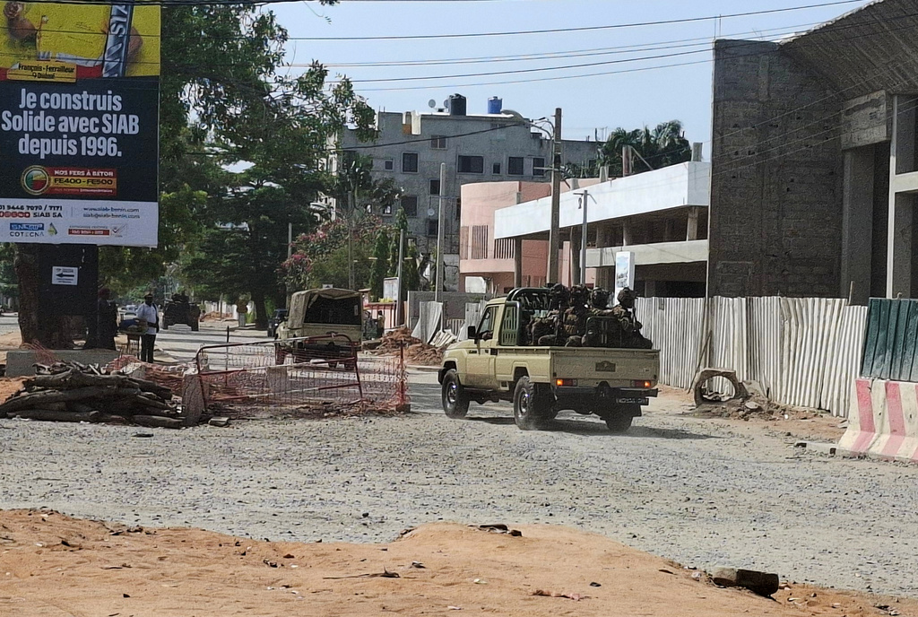 FILE - Soldiers ride in a military vehicle along a street amid an attempted coup in Cotonou Benin, Sunday Dec. 6, 2025. (AP Photo, file)