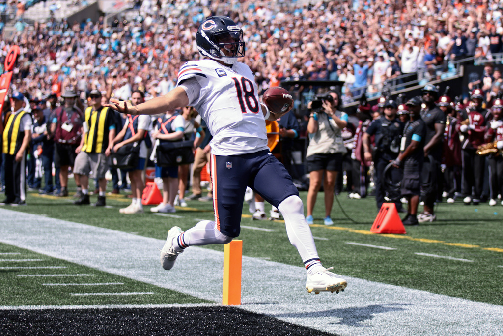 Chicago Bears quarterback Caleb Williams (18) runs to score a touchdown during the first half of an NFL football game, Sunday, Sept. 13, 2026, in Charlotte, N.C. (AP Photo/Scott Kinser)