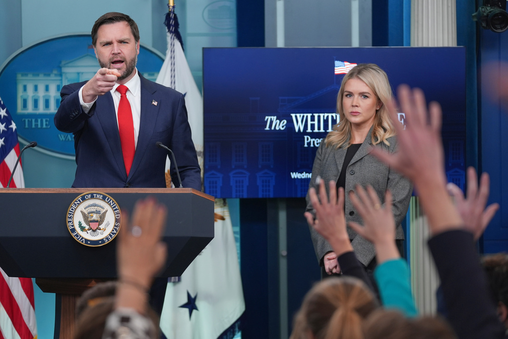 Vice President JD Vance, gestures as he stands with White House press secretary Karoline Leavitt, right, while speaking with reporters in the James Brady Press Briefing Room at the White House, Wednesday, Oct. 1, 2025, in Washington. (AP Photo/Evan Vucci)