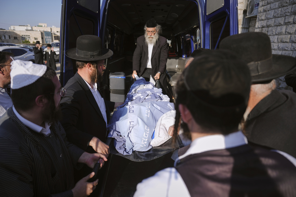 Mourners carry the body of Levi Yitzhak Pash, who was killed along with five other Israelis in a shooting attack by two Palestinian gunmen at a bus stop in Jerusalem, during his funeral, Monday, Sept. 8, 2025. (AP Photo/Ariel Schalit)
