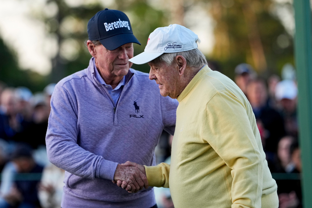 Jack Nicklaus is greeted by Tom Watson during the ceremonial tee shot on the first hole during the first round of the Masters golf tournament at the Augusta National Golf Club, Thursday, April 9, 2026, in Augusta, Ga. (AP Photo/Eric Gay)