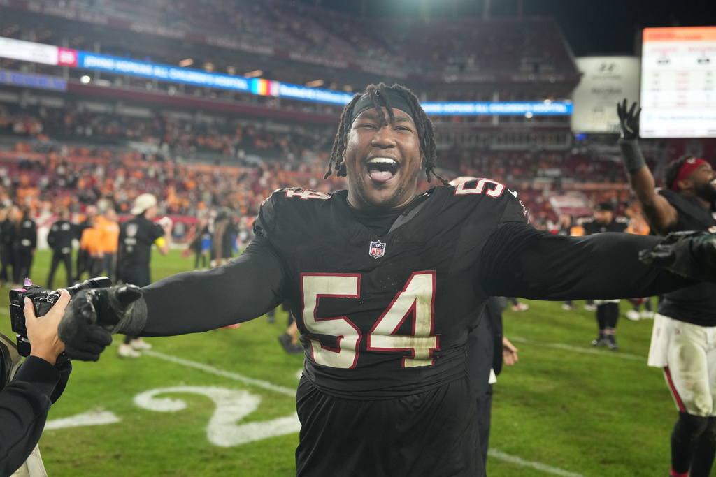FILE - Atlanta Falcons defensive end Brandon Dorlus (54) smiles after the win following an NFL football game against the Tampa Bay Buccaneers, Thursday, Dec 11, 2025, in Tampa, Fla. (AP Photo/Peter Joneleit, File)