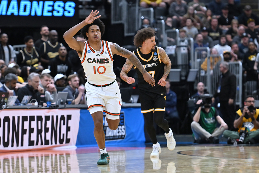 Miami's Tru Washington (10) celebrates after making a 3-point basket as Missouri's Jayden Stone, right, is seen in the background during the first half in the first round of the NCAA college basketball tournament, Friday, March 20, 2026, in St. Louis. (AP Photo/Ali Overstreet)