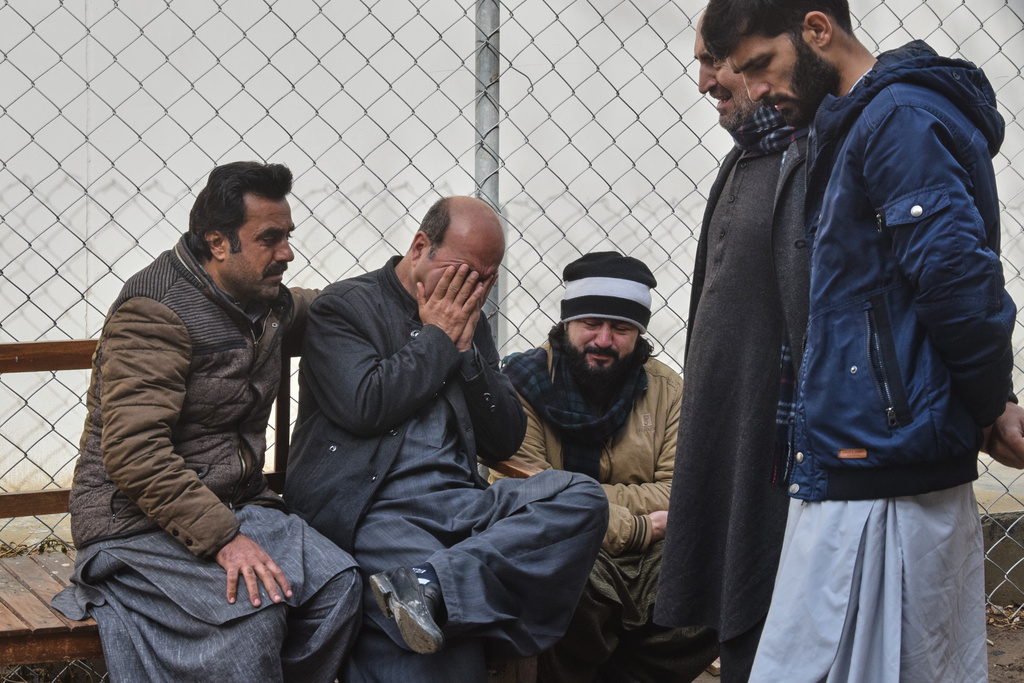 Relatives of police officers who were killed in a militants attack, mourn outside a hospital in Quetta, Pakistan, Saturday, Jan. 31, 2026. (AP Photo/Arshad Butt)