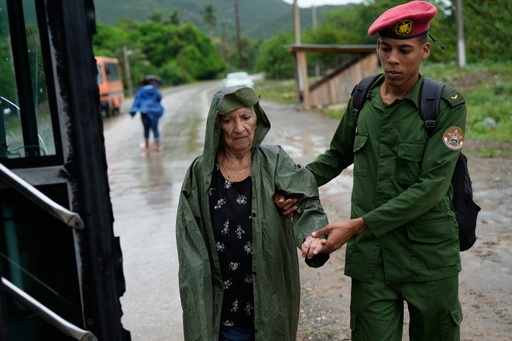 A soldier helps a woman evacuate before the arrival of Hurricane Melissa in Canizo, a community in Santiago de Cuba, Tuesday, Oct. 28, 2025. (AP Photo/Ramon Espinosa) A soldier helps a woman evacuate before the arrival of Hurricane Melissa in Canizo, a community in Santiago de Cuba, Tuesday, Oct. 28, 2025. (AP Photo/Ramon Espinosa)