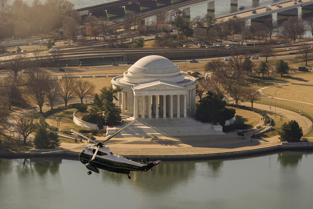 Marine One, with President Donald Trump aboard, flies past the Jefferson Memorial, Tuesday, Jan. 13, 2006, in Washington, after departing the White House, enroute to Joint Base Andrews and onto Detroit. (AP Photo/Pablo Martinez Monsivais)